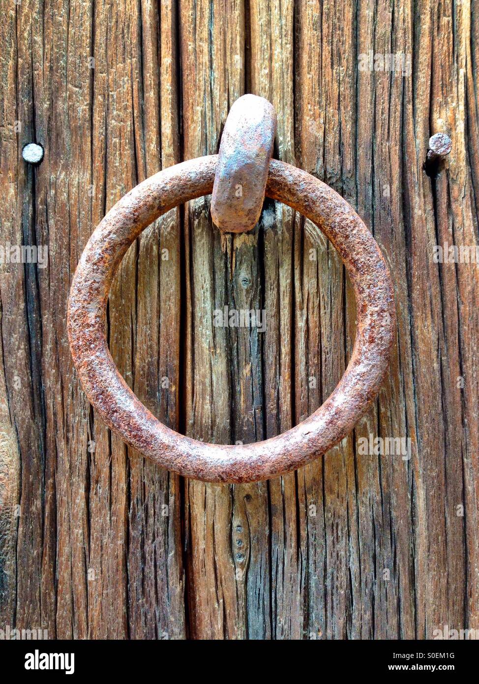Iron ring attached to old barn boards - Smartphone Captured Stock Image
