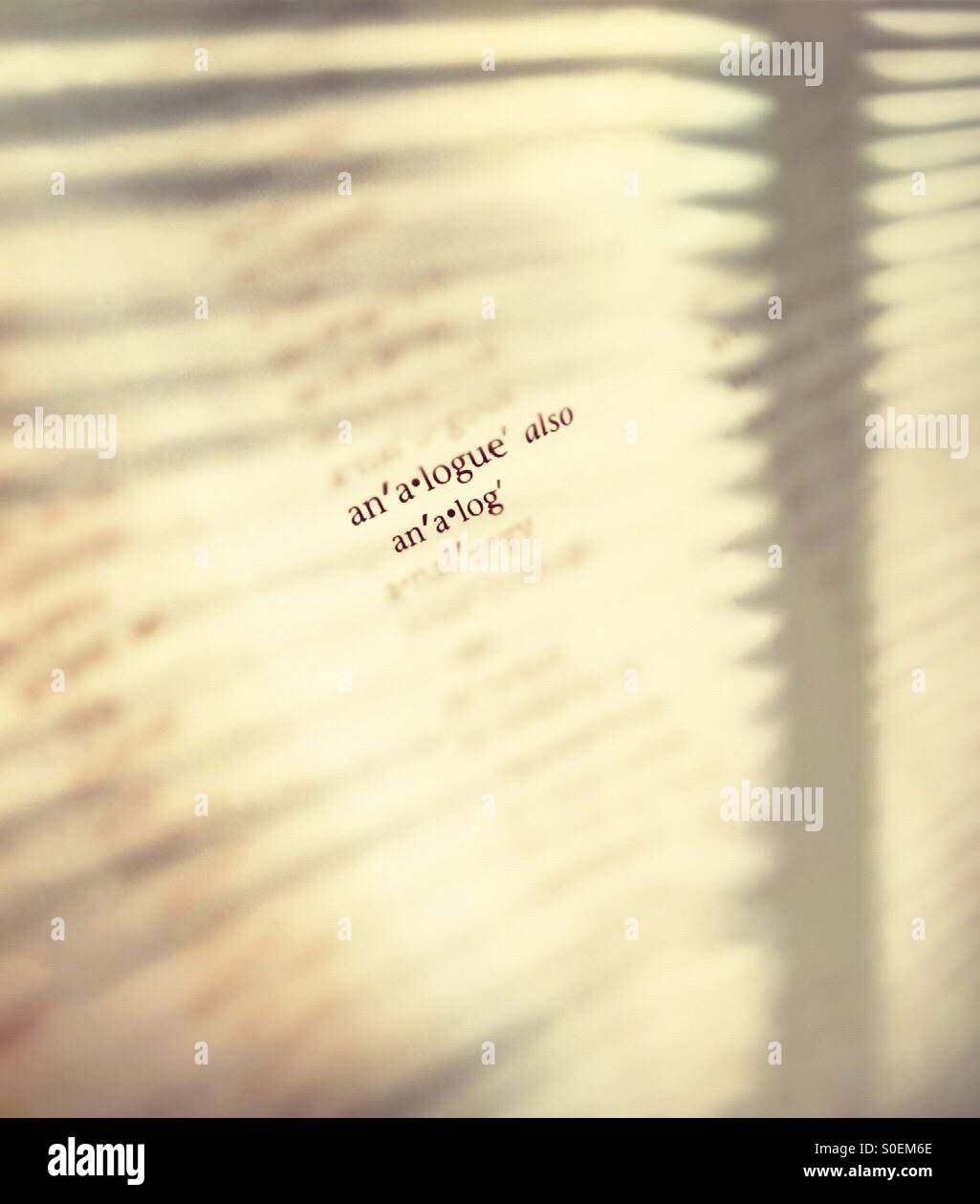 Analog and analogue on otherwise blank sheet on paper - Smartphone Captured Stock Image