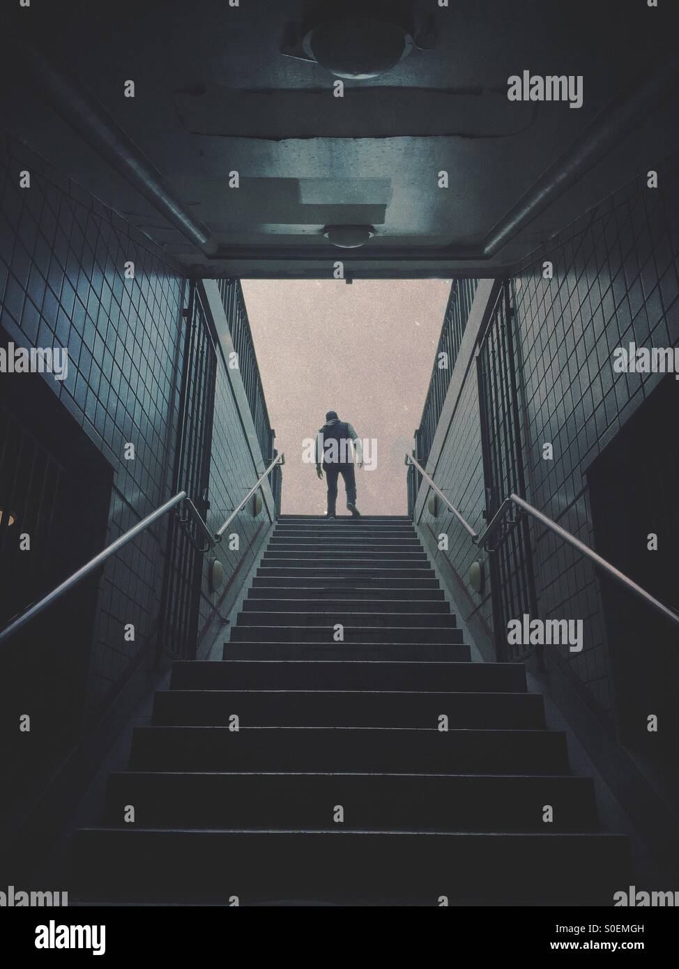 Mysterious male figure leaving the subway station Stock Photo