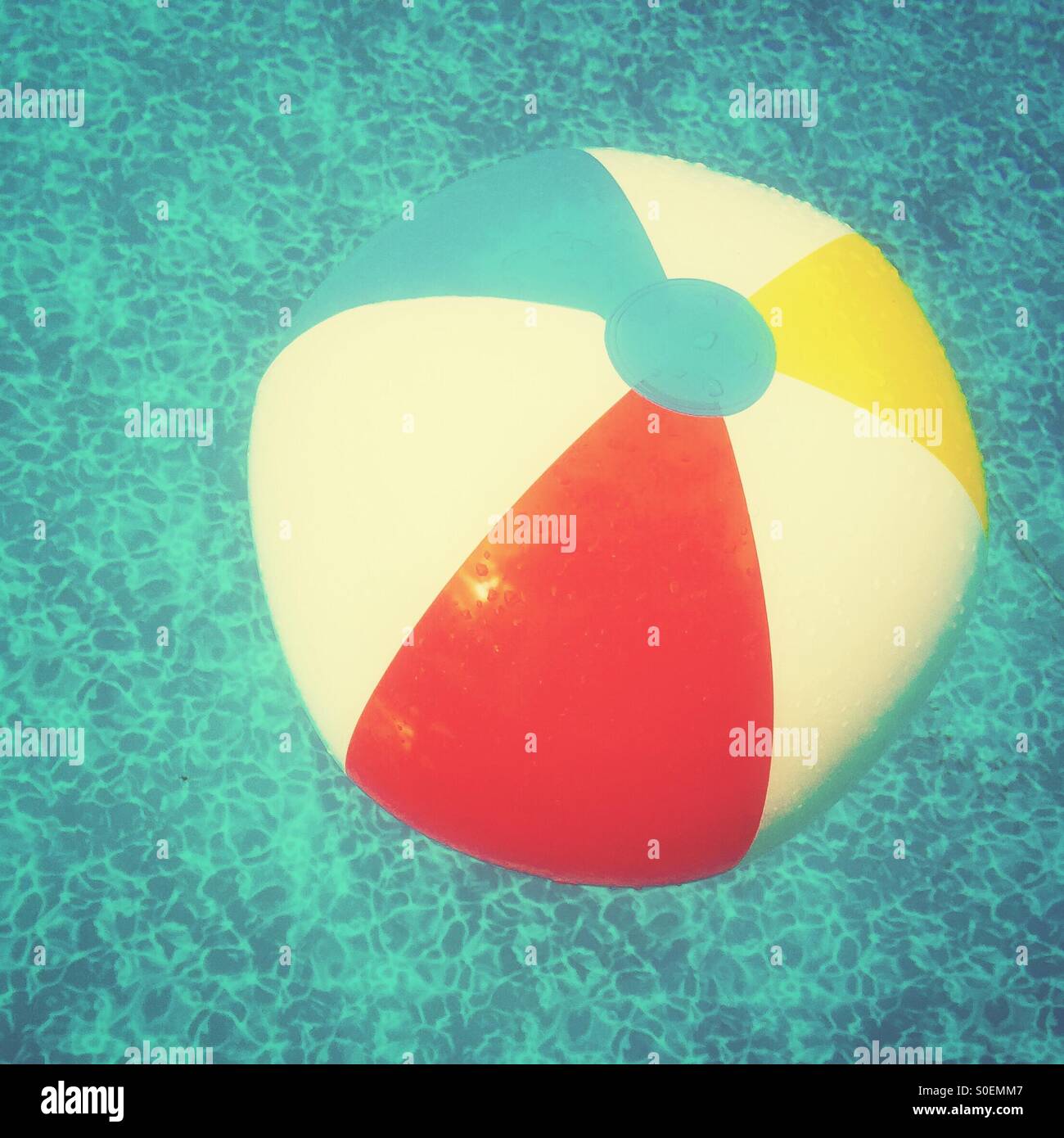 Beach ball in swimming pool. Retro feel Stock Photo Alamy