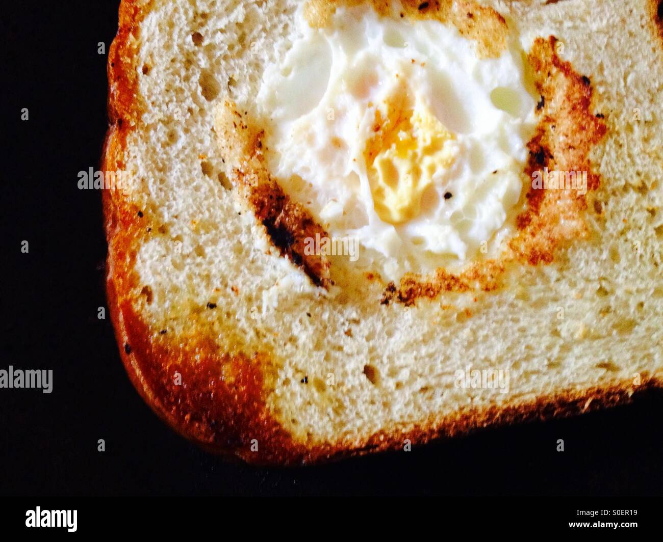 Egg surprise (fried egg in the centre of a slice of fried bread Stock