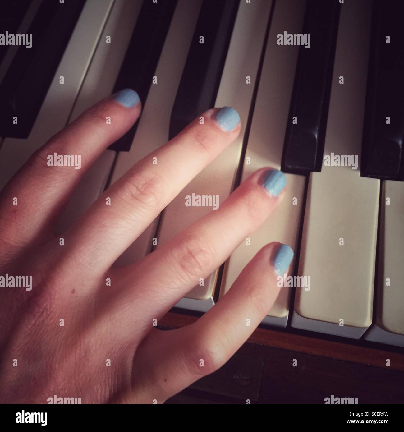 Hand playing the piano Stock Photo