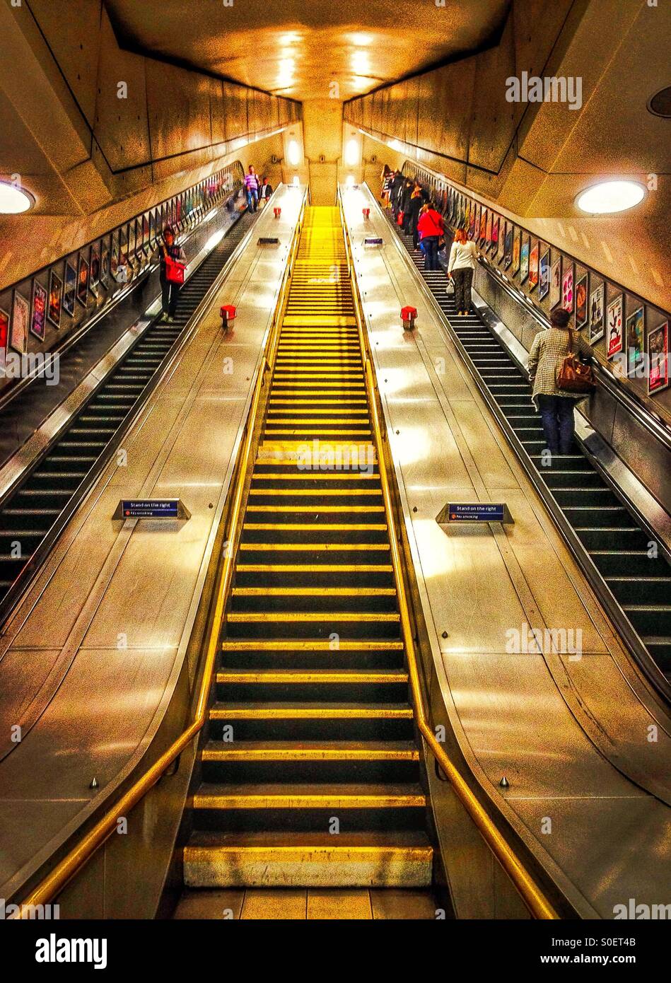Stairs and escalator at Sloane Square station. Stock Photo