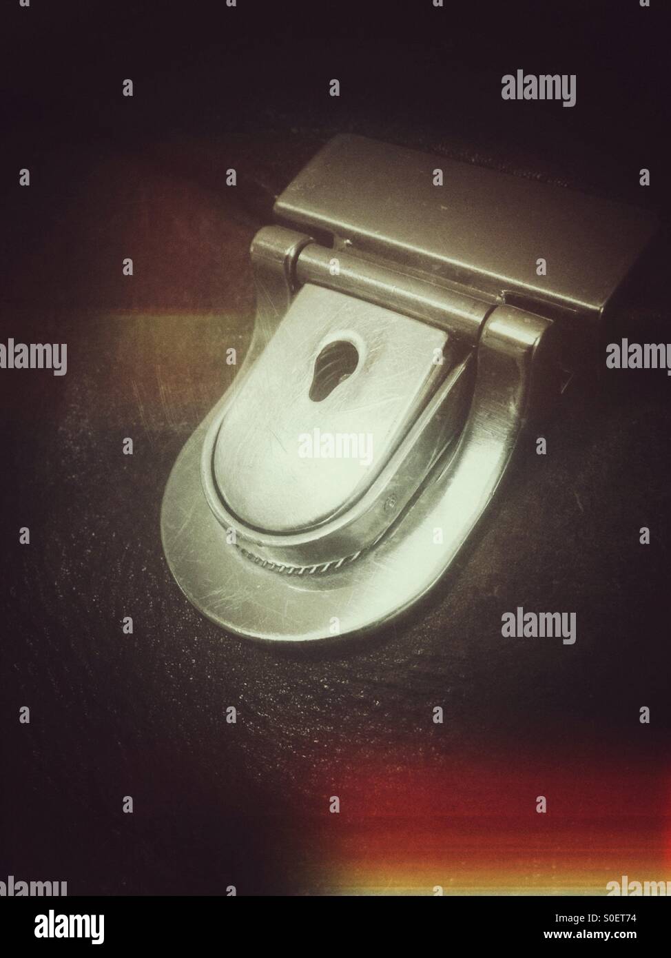 Metal lock or clasp on a Brown leather Bag - Smartphone Captured Stock Image