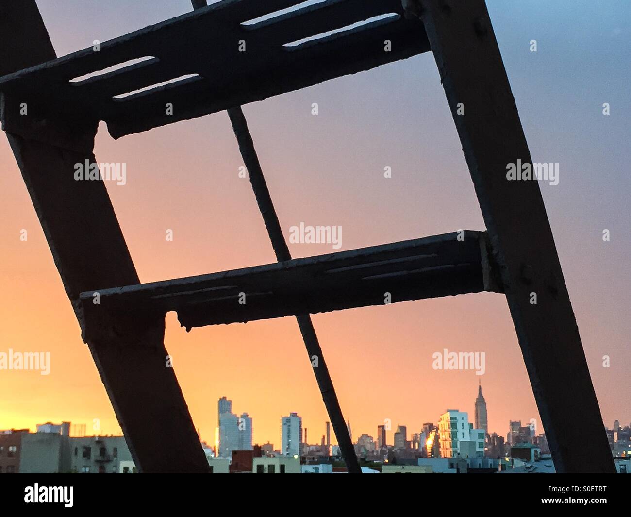 Empire State Building through the view of a fire escape window in Williamsburg Brooklyn. Stock Photo