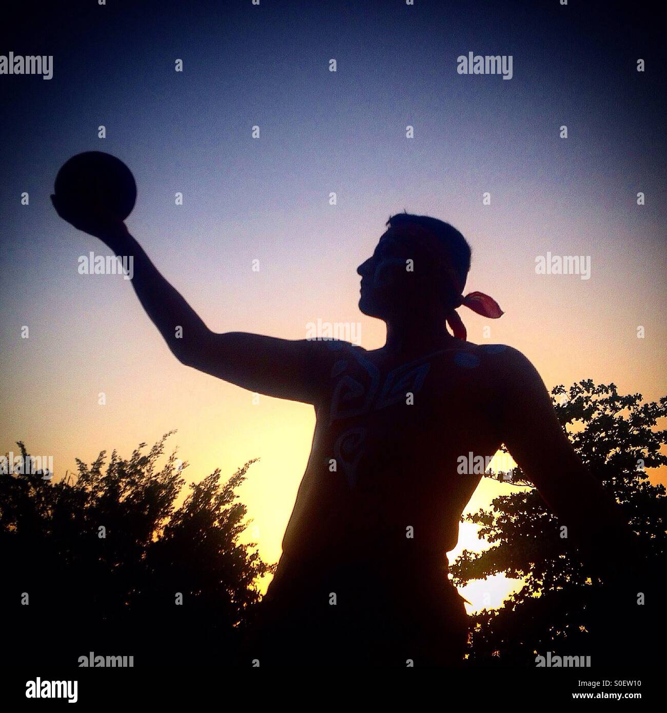 A player of ceremonial Pok ta Pok, the ritual Mayan ball game, holds