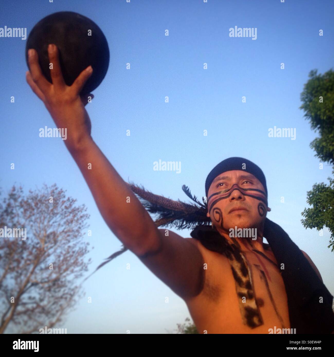 A player of ceremonial Pok ta Pok, the ritual Mayan ball game, holds