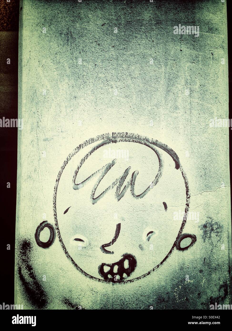 Graffiti of a boy's Head in Berlin - Smartphone Captured Stock Image