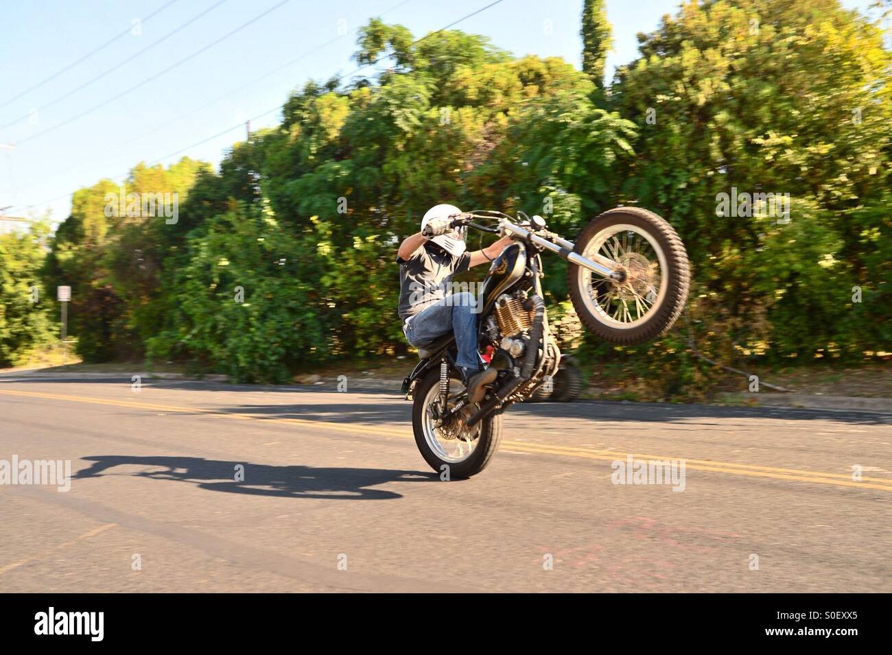 Motorcycle wheelie action in Austin, Texas, USA. Stock Photo