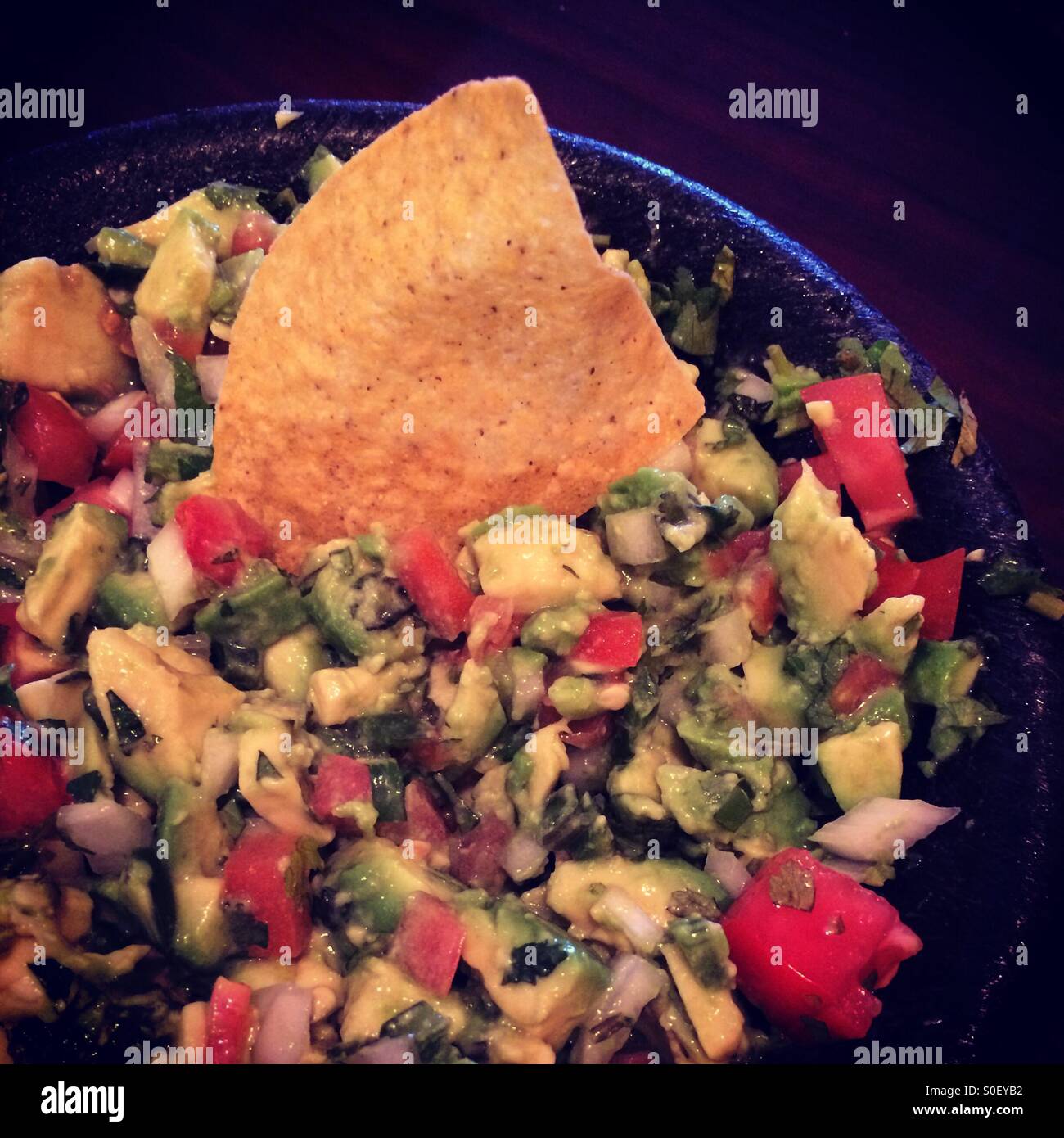 A bowl of guacamole with Chip. Stock Photo