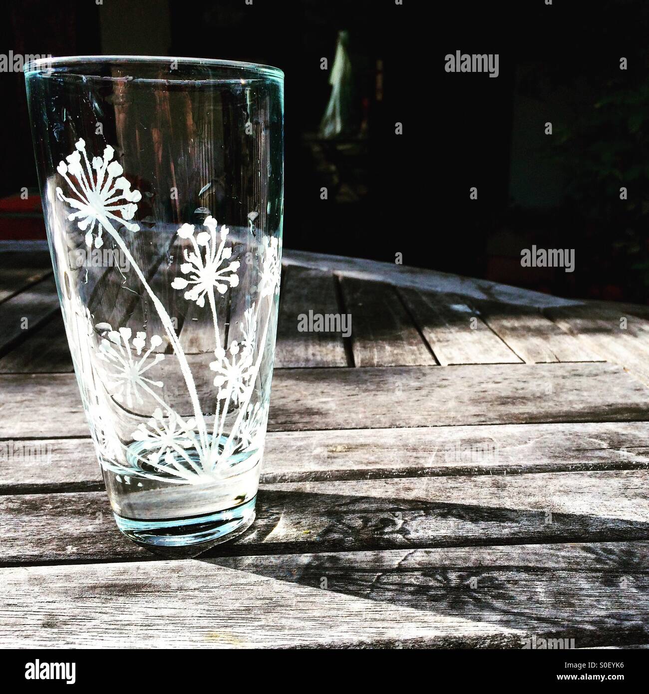 Glass on table catching sunlight - Smartphone Captured Stock Image