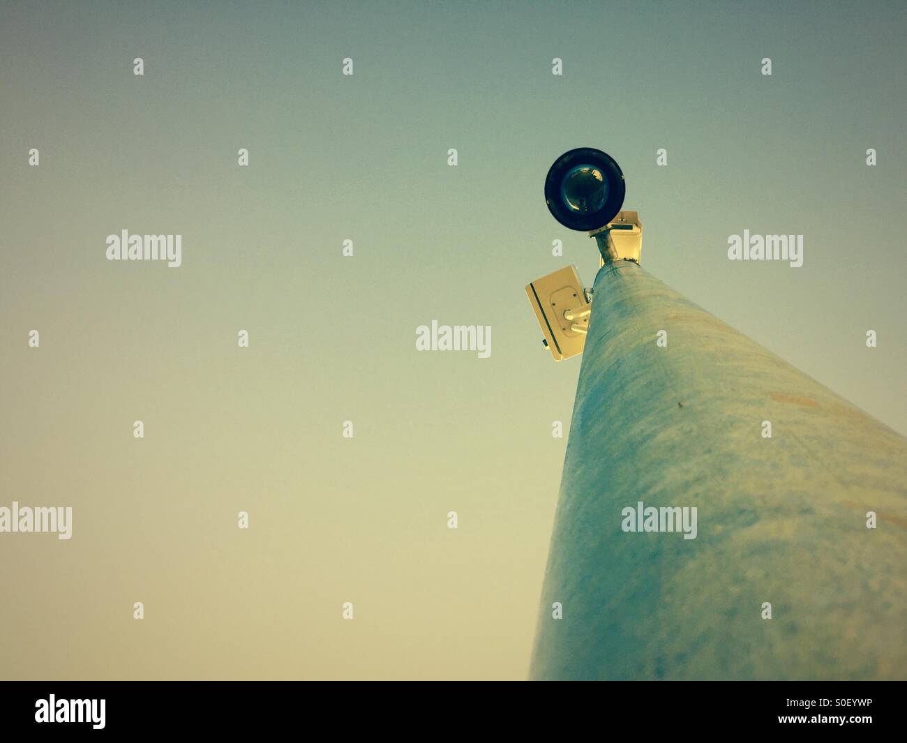 A CCTV camera on a mast watching - Smartphone Captured Stock Image