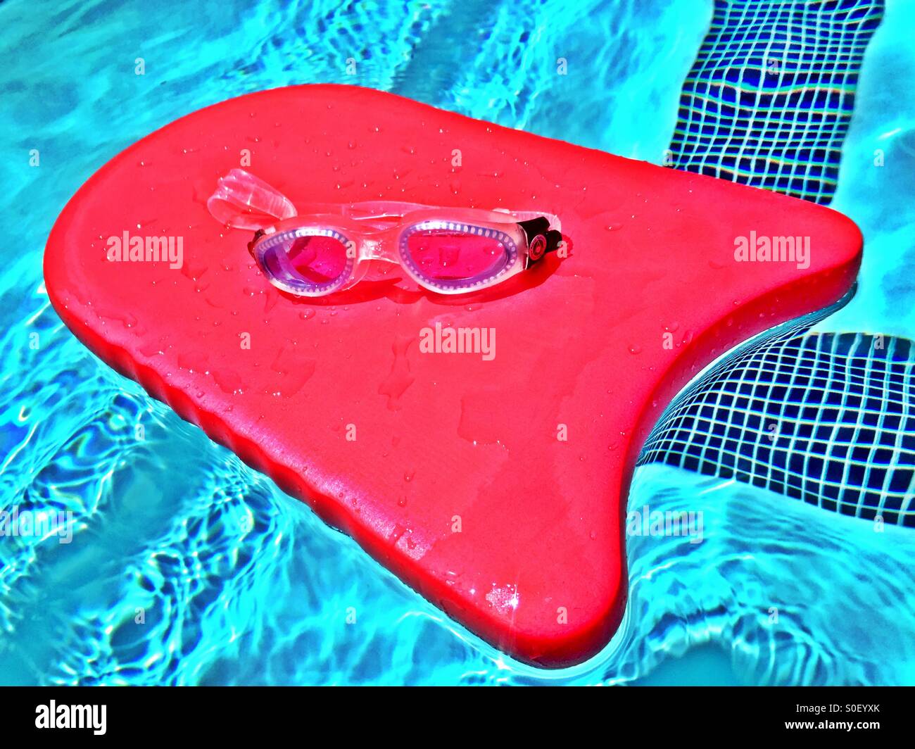 Kickboard floating in the pool with swim goggles on a sunny day in Northern California - Smartphone Captured Stock Image
