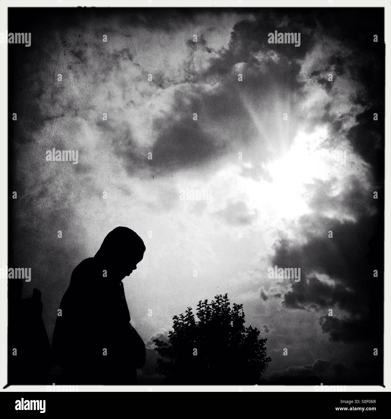 Silhouete of a person passing by on a cloudy day in London - Smartphone Captured Stock Image