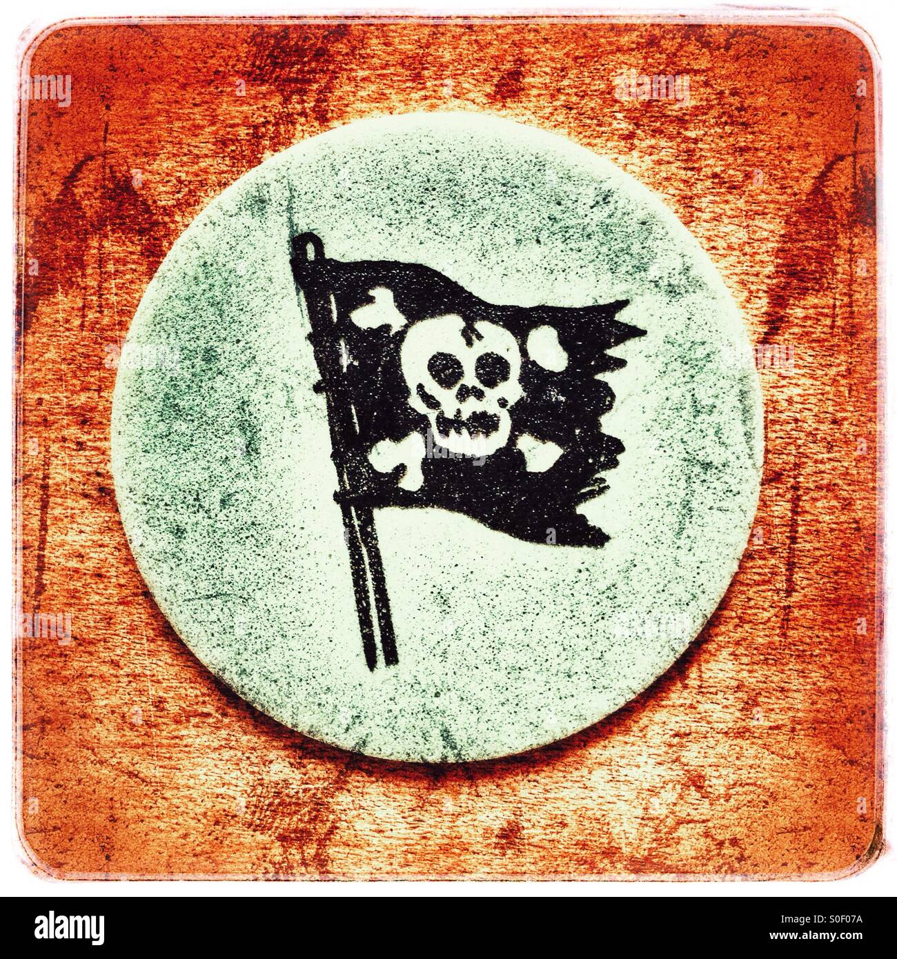 A tongue tattoo of a pirate flag with crossbones and skull printed on edible paper for children - Smartphone Captured Stock Image