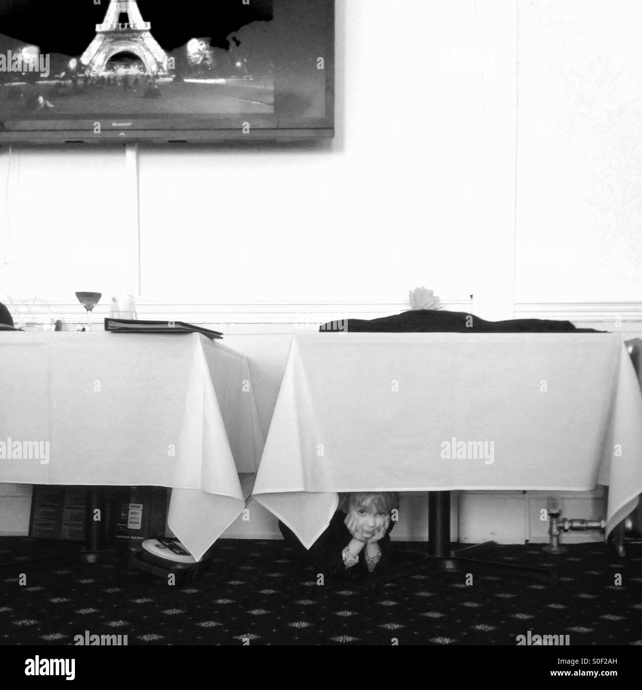 Boy hiding under a table - Smartphone Captured Stock Image