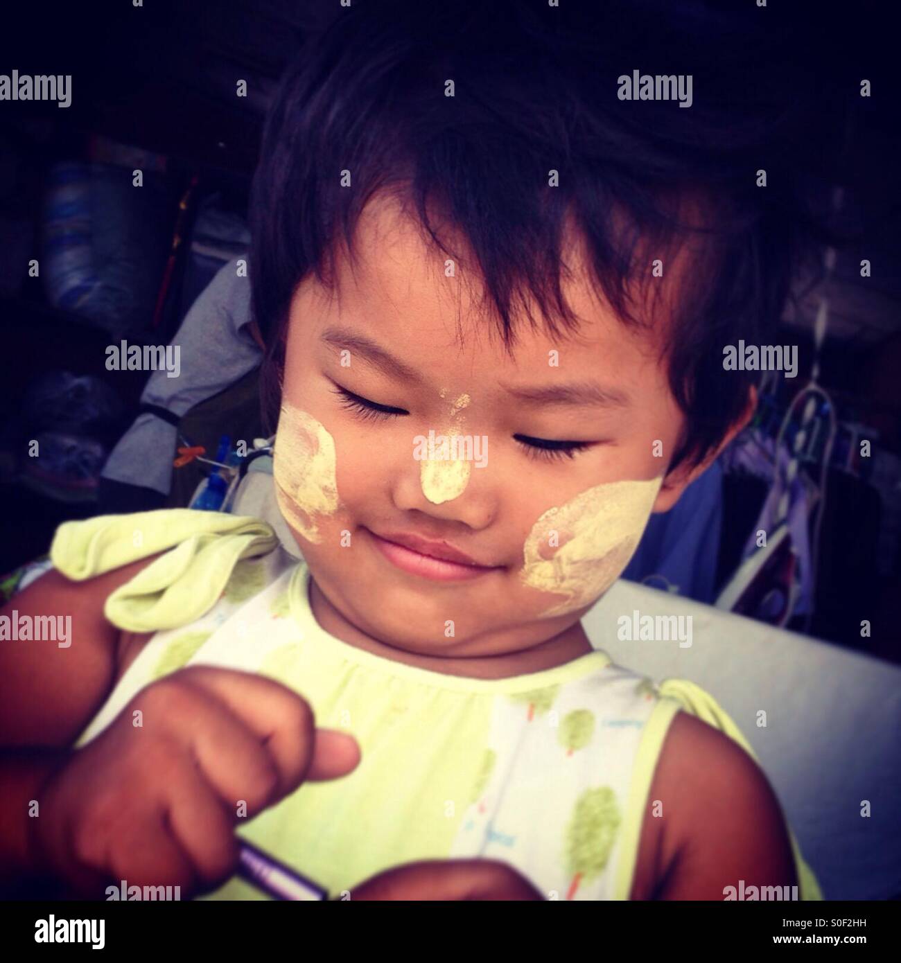 Toddler with sun protection on cheeks and nose, Thailand Stock Photo