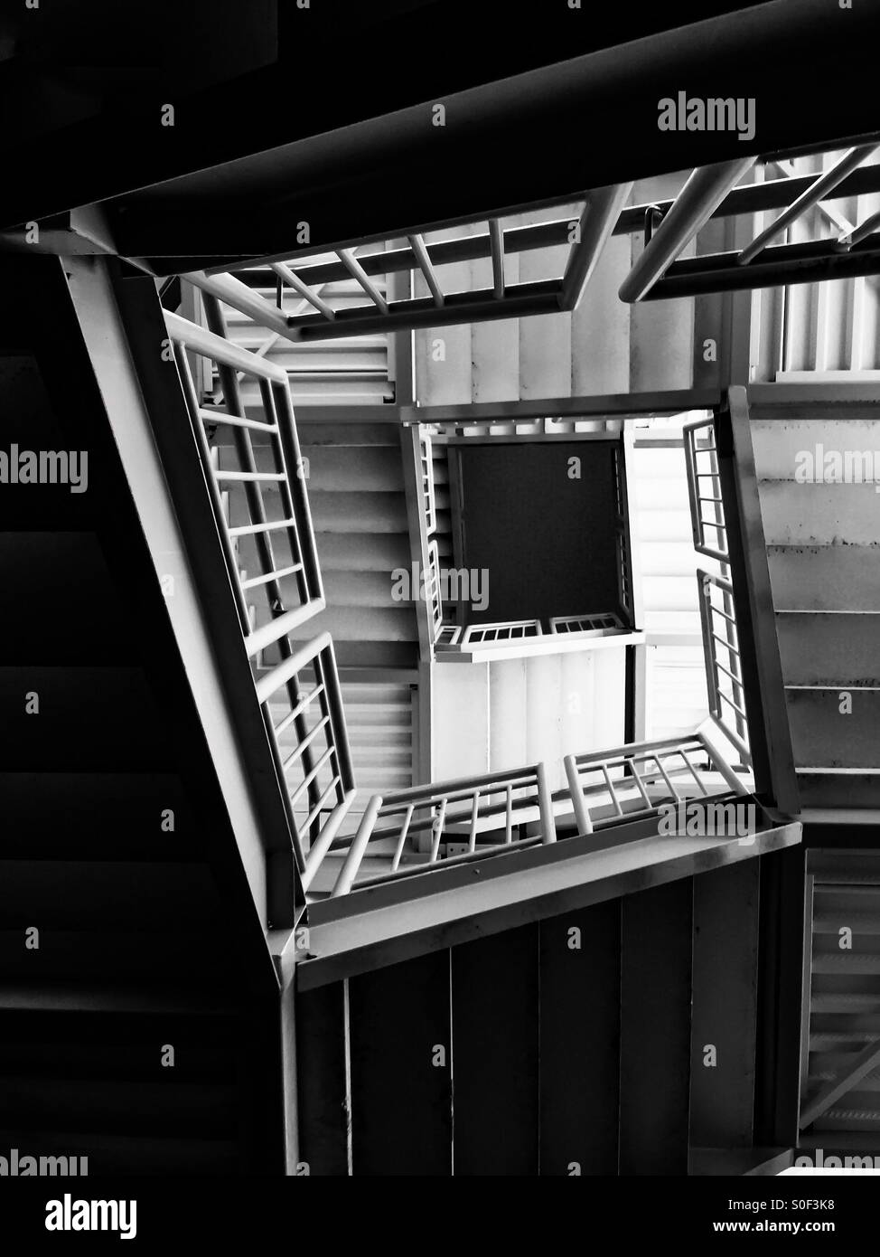 Square staircase inside a modern building, Ontario, Canada. Straight lines and steps in a narrow space. - Smartphone Captured Stock Image
