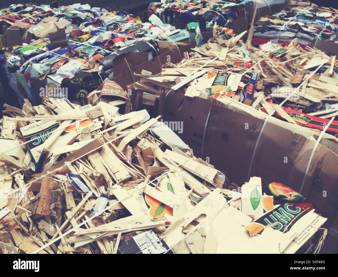 Bales of Used Paper and cardboard and Wood Boxes and crates waiting to ne picked up for Recycling - Smartphone Captured Stock Image