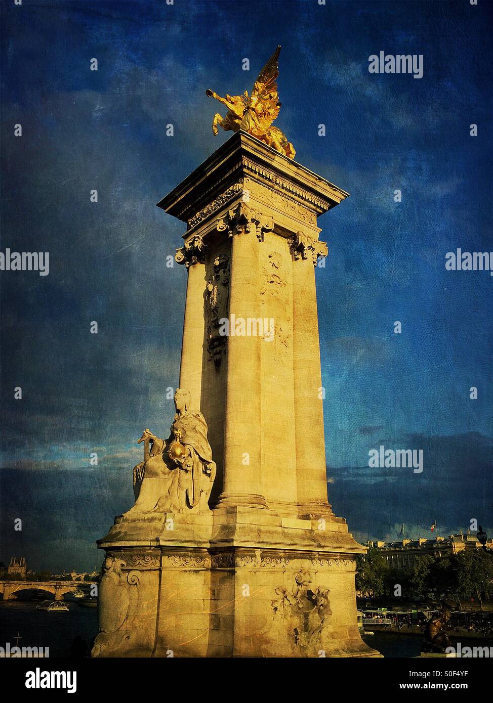 Gilt-bronze statue of a Fame restraining Pegasus watches over the Pont Alexandre III bridge, supported on massive masonry socles. Paris, France. French Monument historique. Vintage texture overlay. Stock Photo