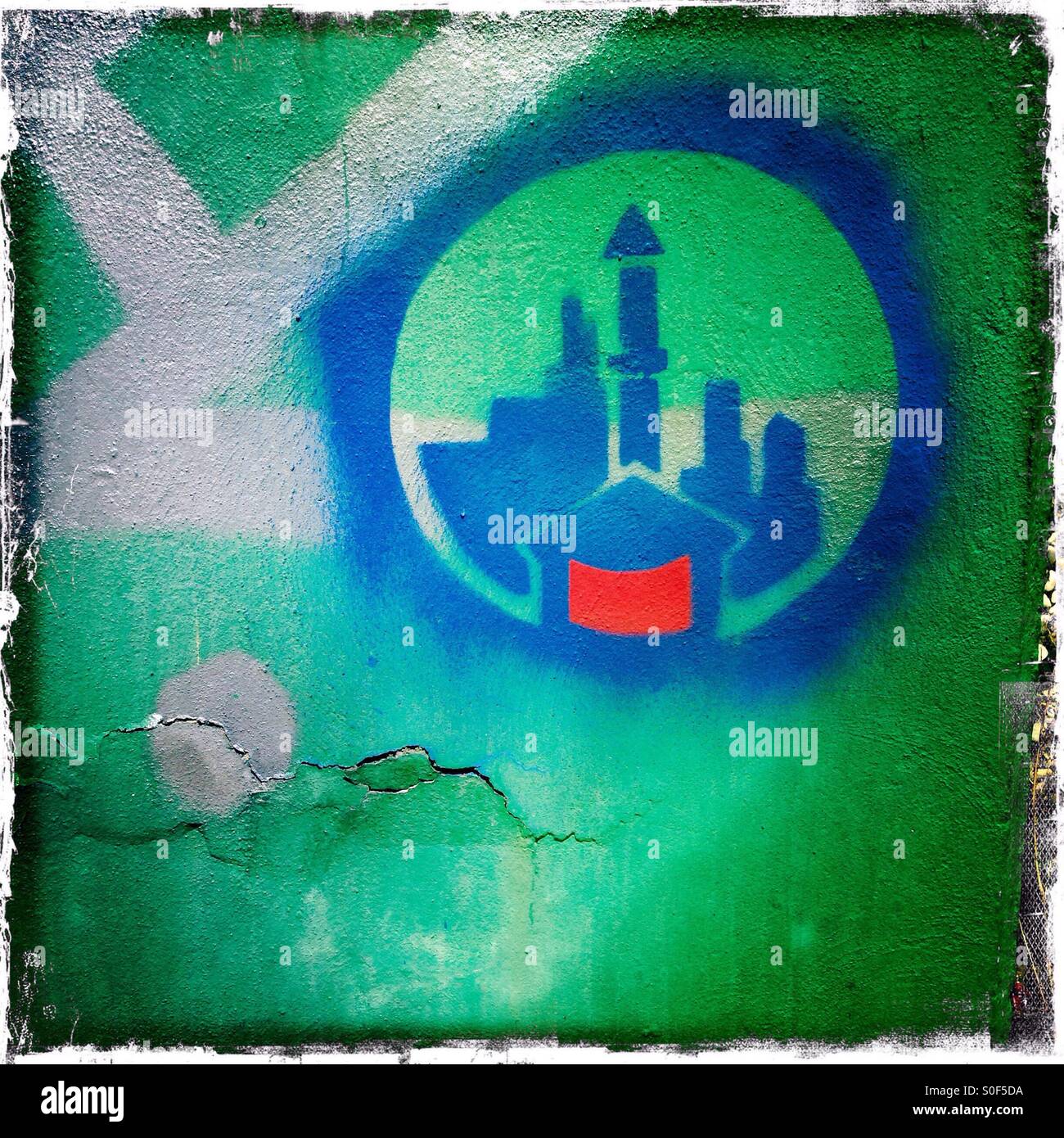 Stencil Graffiti on a wall in Berlin of a Mosque with Minaret dominating the Skyline of a City Stock Photo