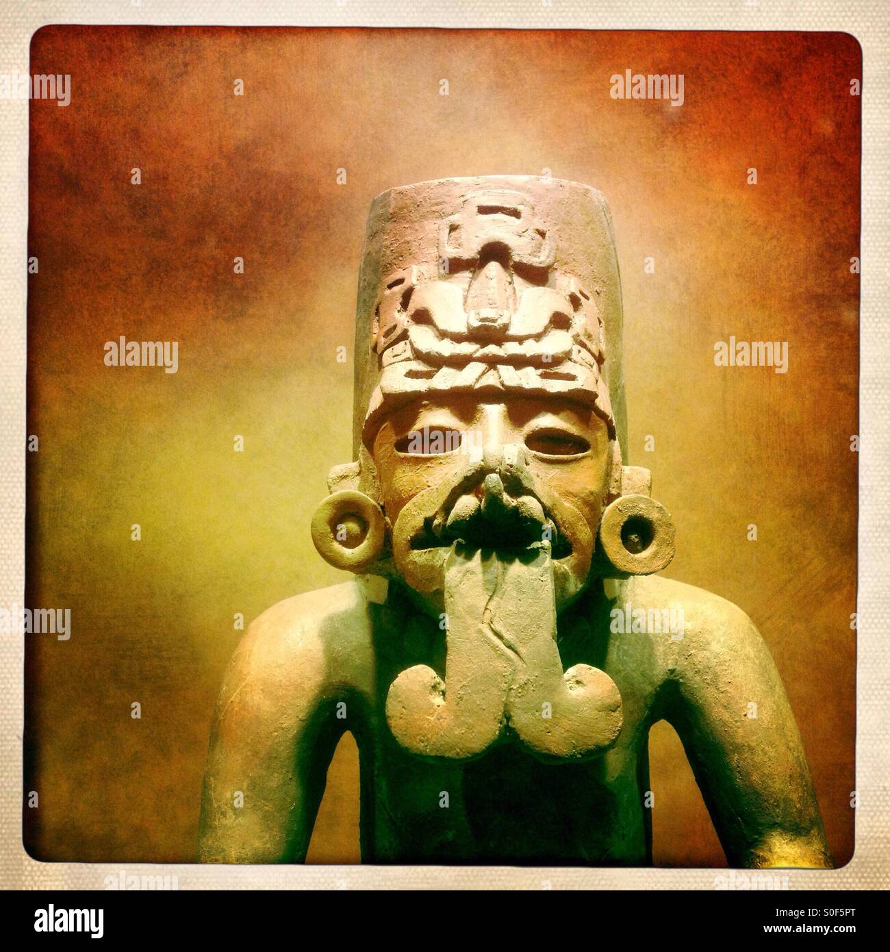 A Oaxacan priest sculpture with a bifid tongue found in the Zapotec neighborhood of Teotihuacan is displayed in the National Museum of Anthropology of Mexico City, Mexico - Smartphone Captured Stock Image