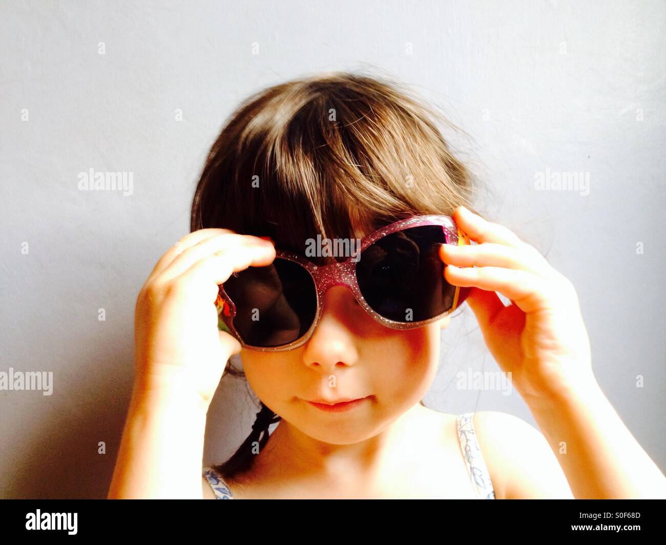 3-year old girl wearing sunglasses Stock Photo