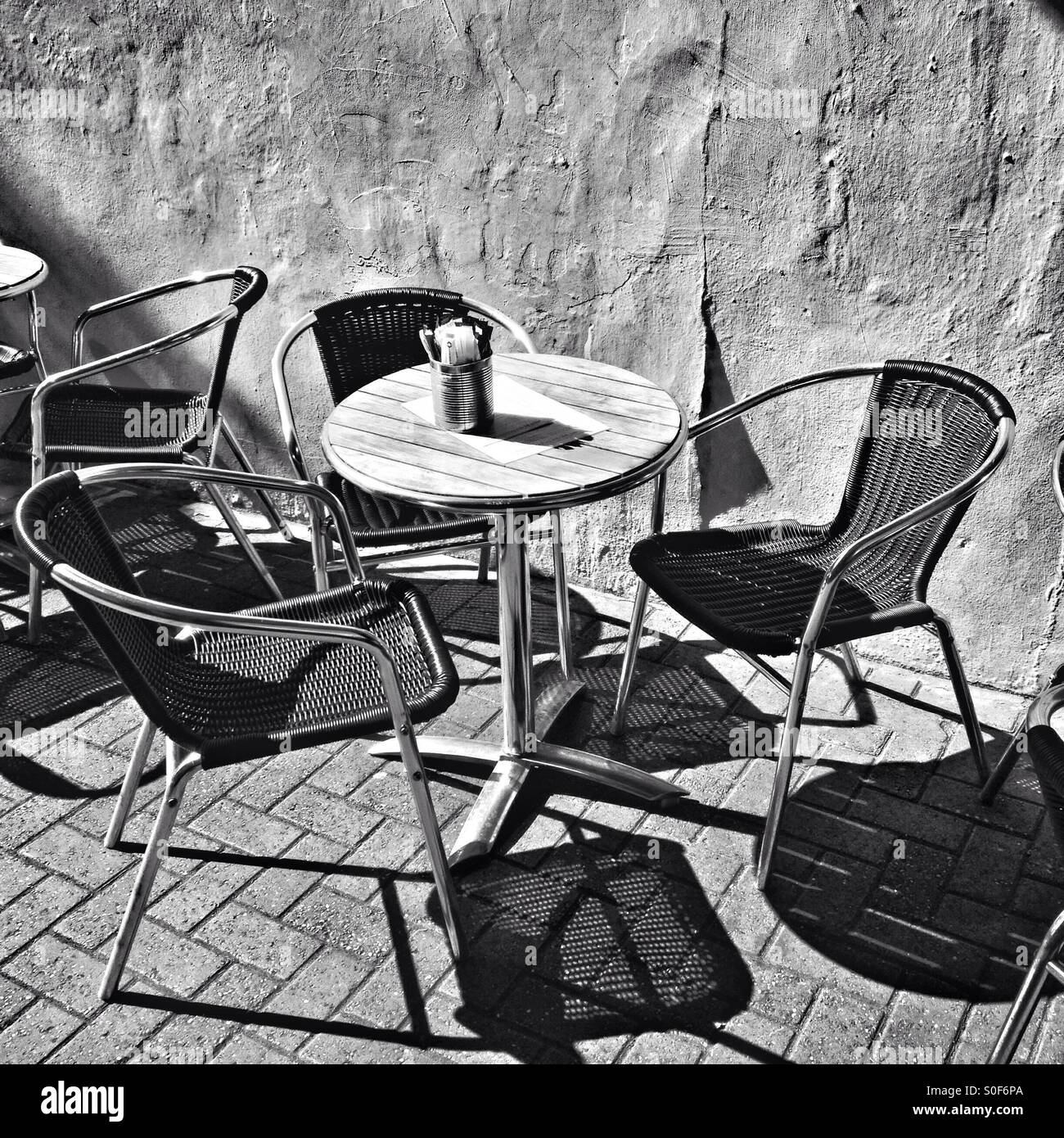 A table and chairs outside a café - Smartphone Captured Stock Image