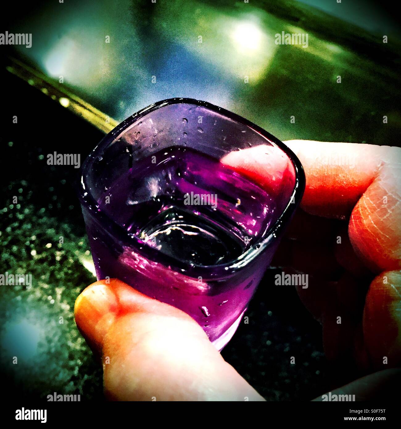 Chilled violet colored shot glass inviting consumption of its contents. - Smartphone Captured Stock Image