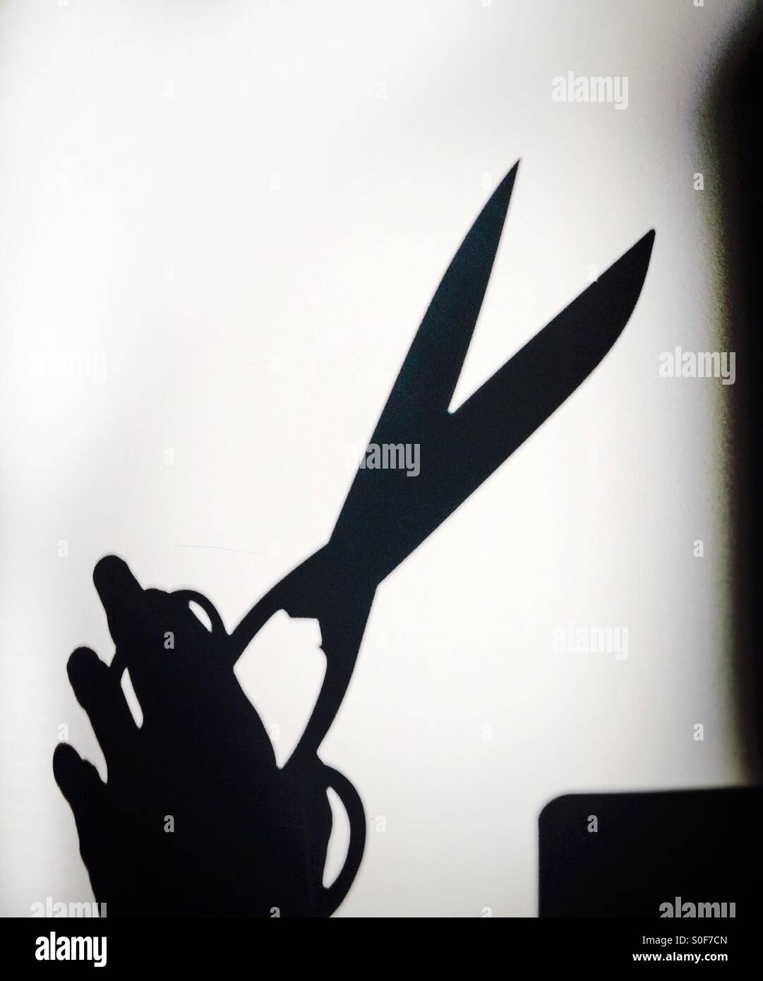 Shadow of a scissors on white background Stock Photo