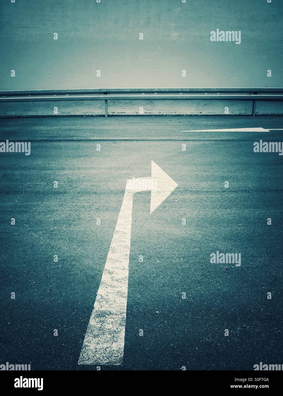 Painted white direction arrow - Smartphone Captured Stock Image