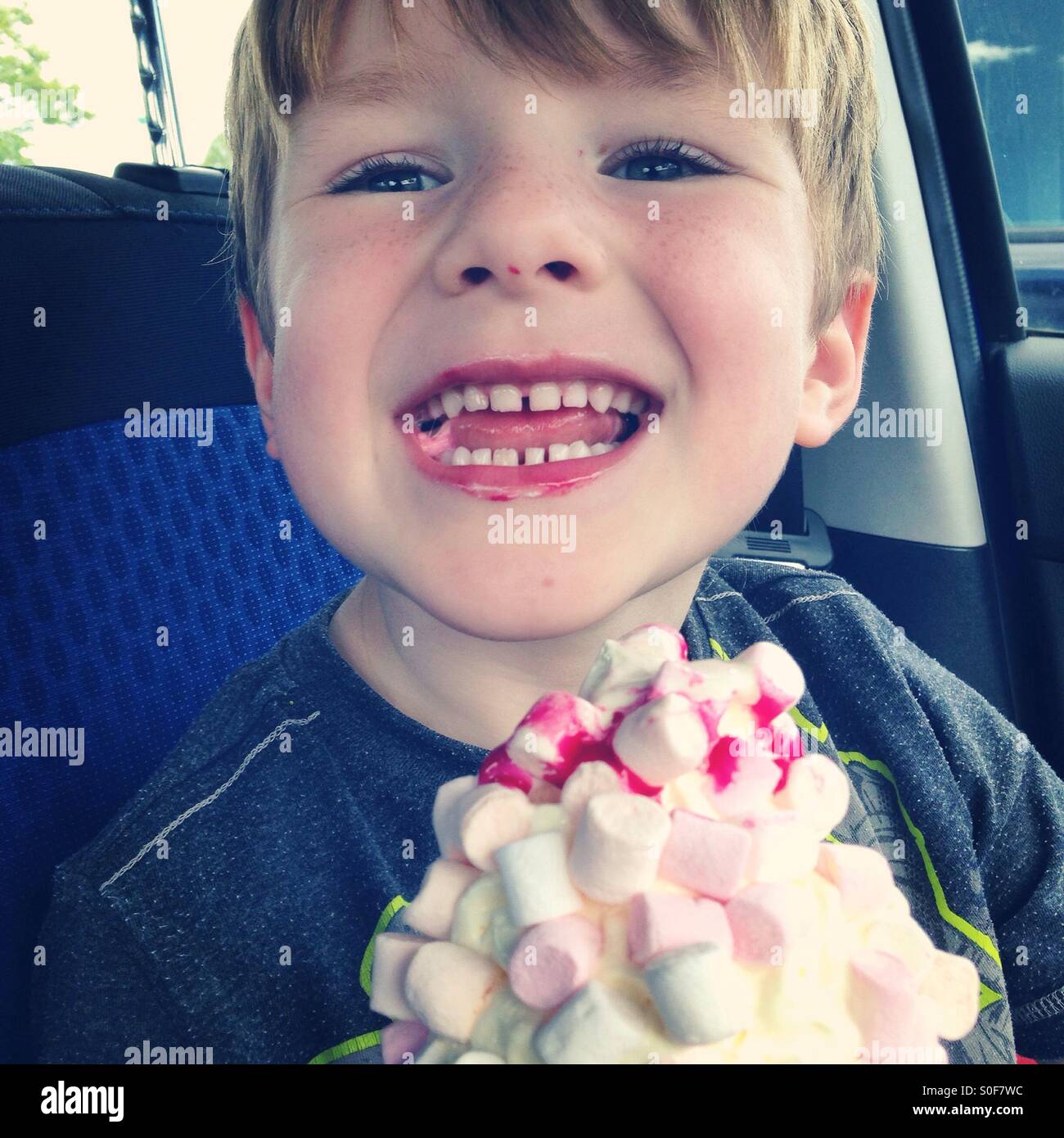 Boy eating a marshmallow icecream Stock Photo Alamy