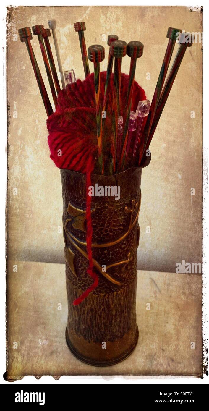 WWI trench art vase made from 20-pounder. Holding knitting needles and ball of yarn. Stock Photo