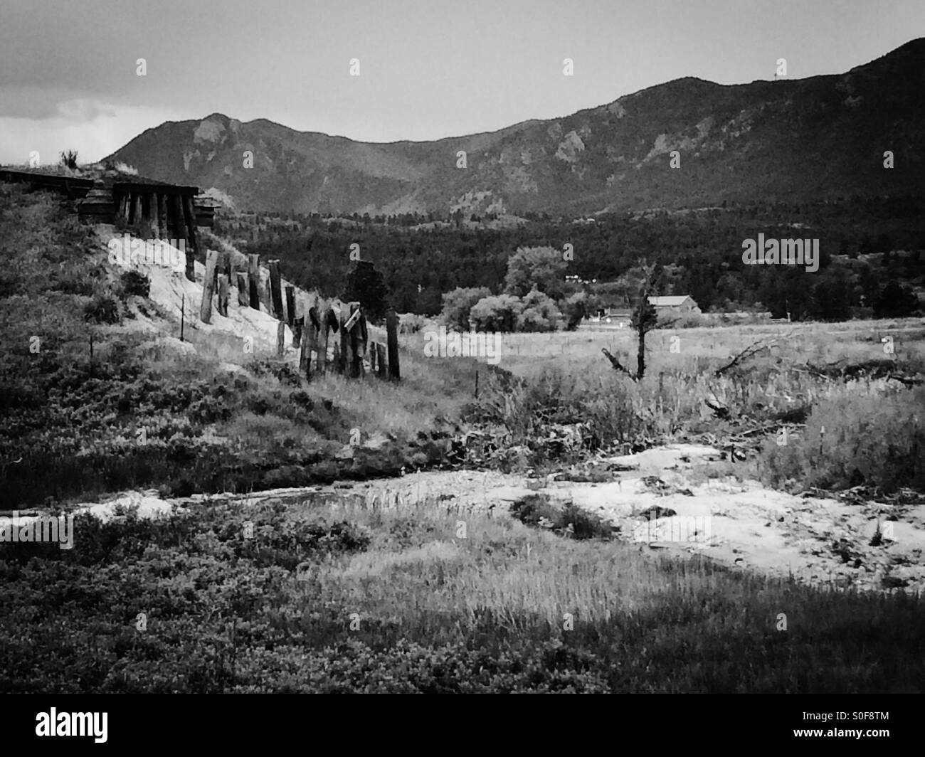 Old railroad train bridge over creek in Colorado Rocky Mountains black and white. Stock Photo