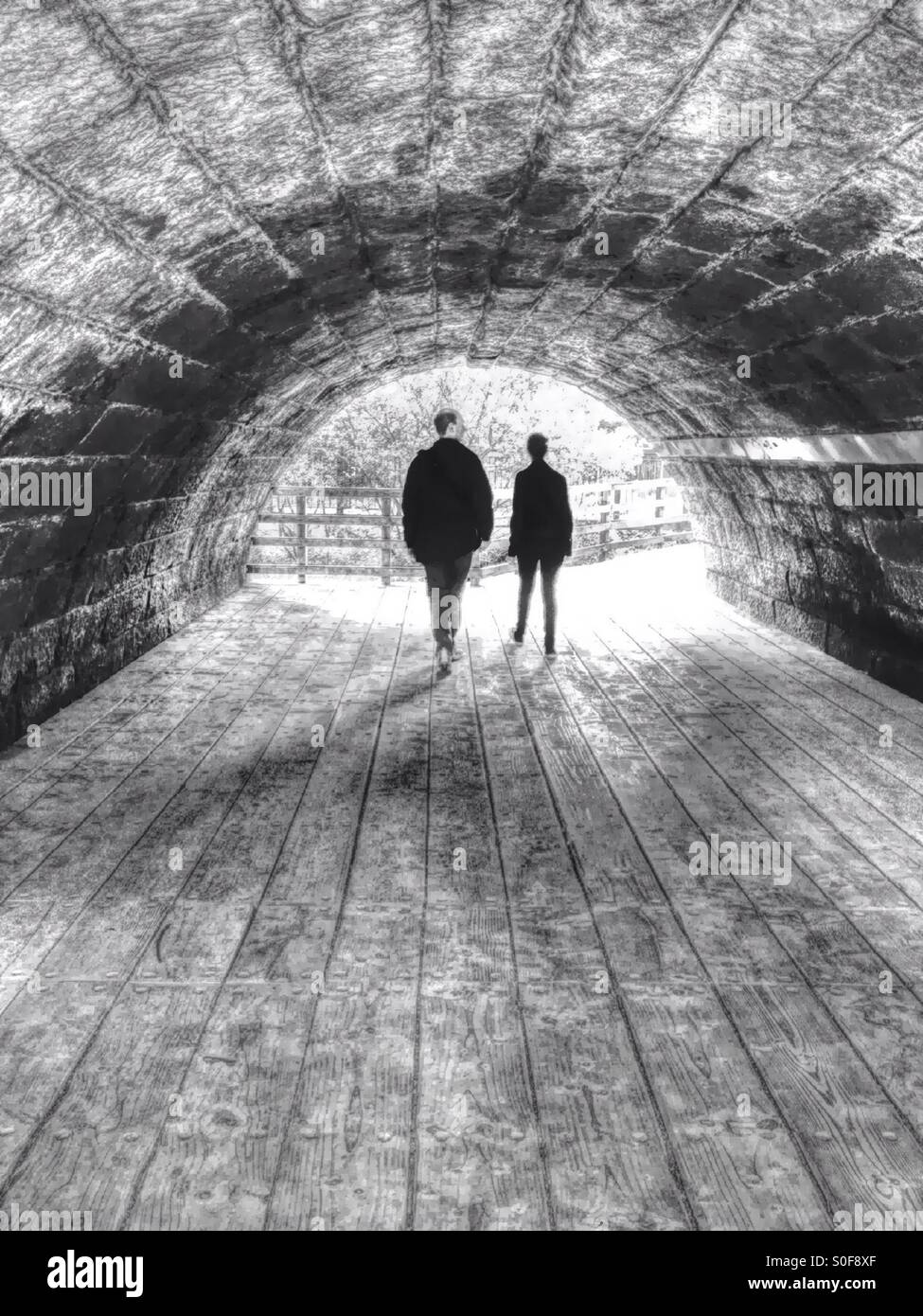 Two people at end of a tunnel - Smartphone Captured Stock Image