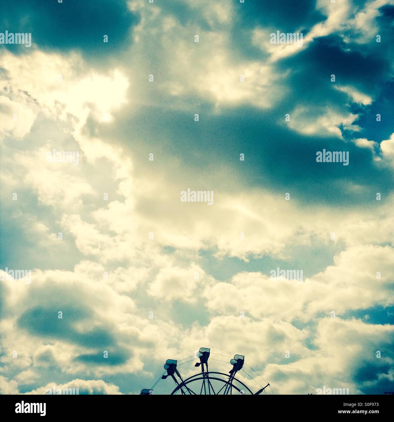 A Ferris wheel and clouds. Stock Photo