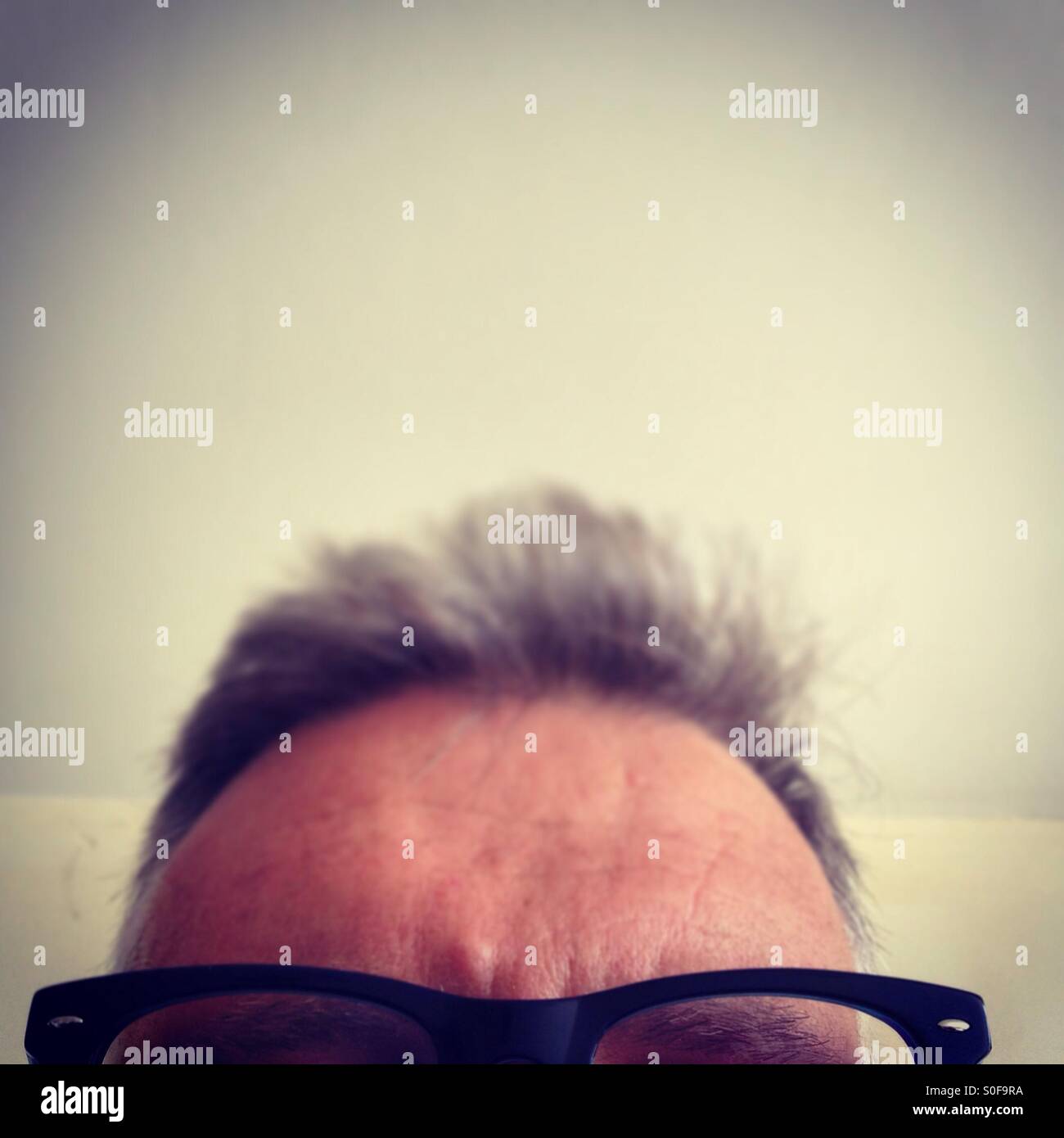 Top of Middle aged man's head with glasses - Smartphone Captured Stock Image