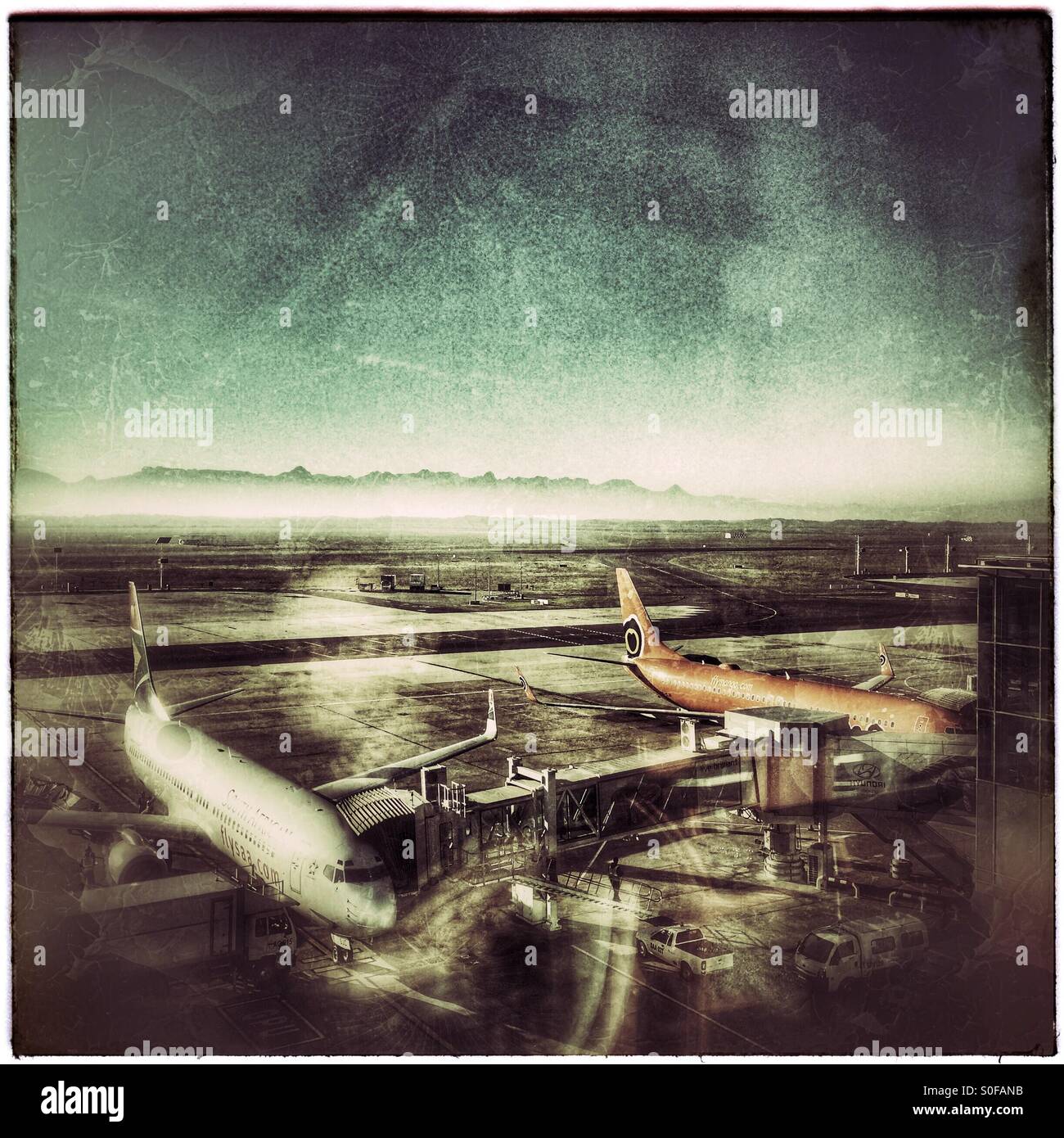 Planes getting cleaned and refueled for their next flights, Cape Town International Airport , South Africa. - Smartphone Captured Stock Image