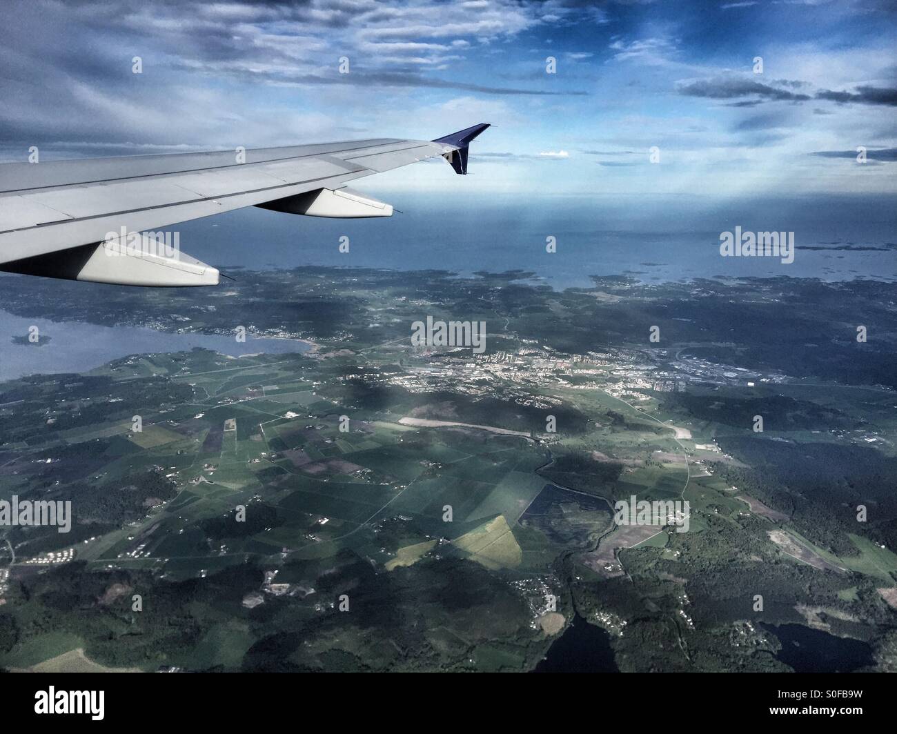 View from an airplane flying over a city - Smartphone Captured Stock Image