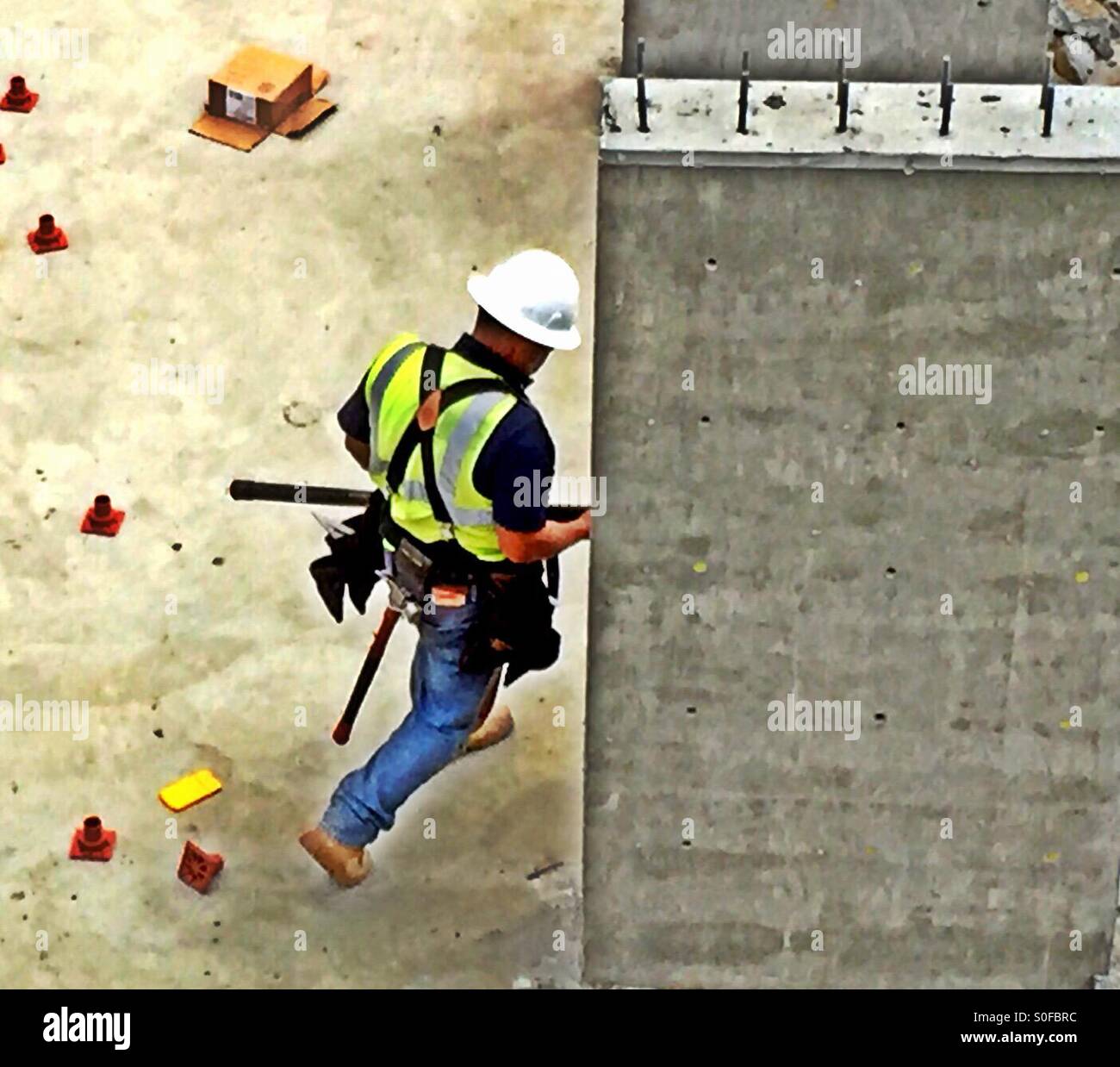 Construction worker installs electrical conduit in foundation of new home project. San Francisco