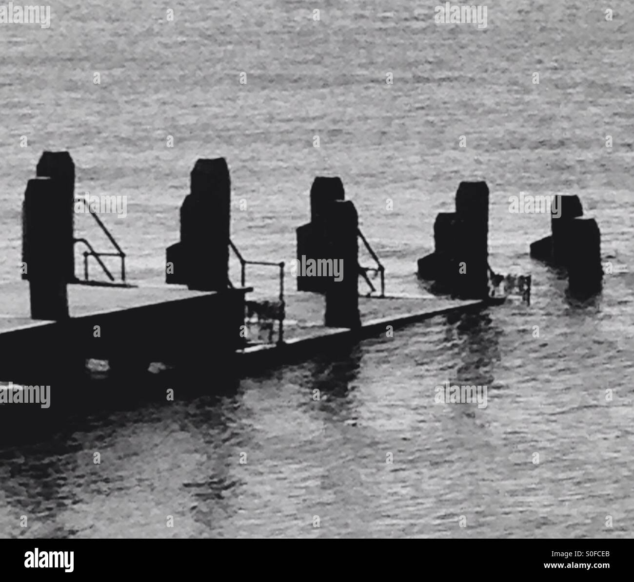 Black and white photo of Wave breakers at seaside - Smartphone Captured Stock Image