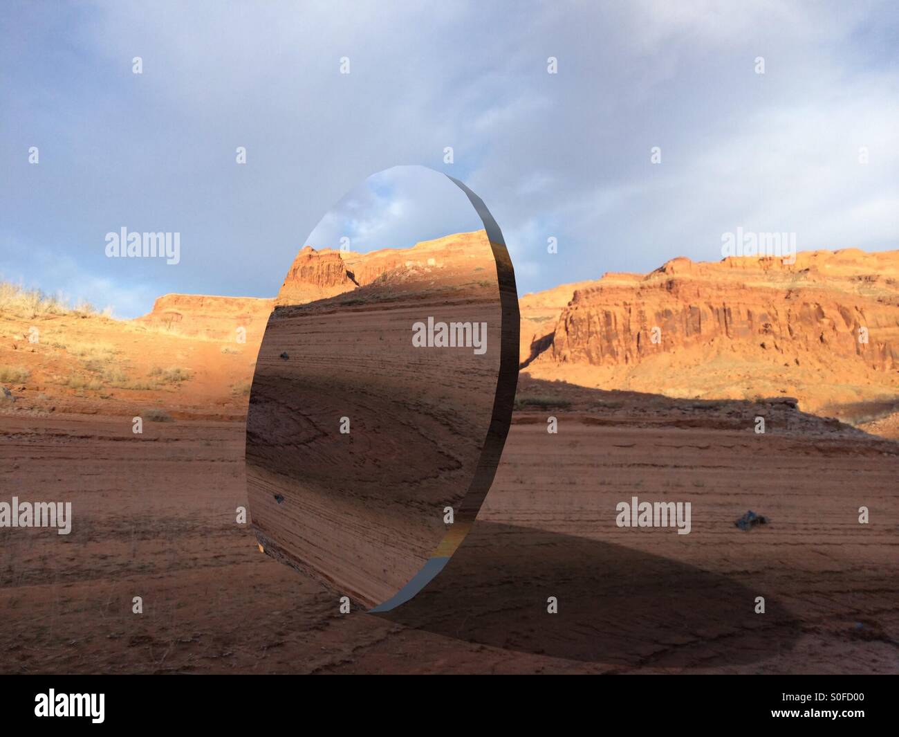 Large round mirror in desert Stock Photo Alamy