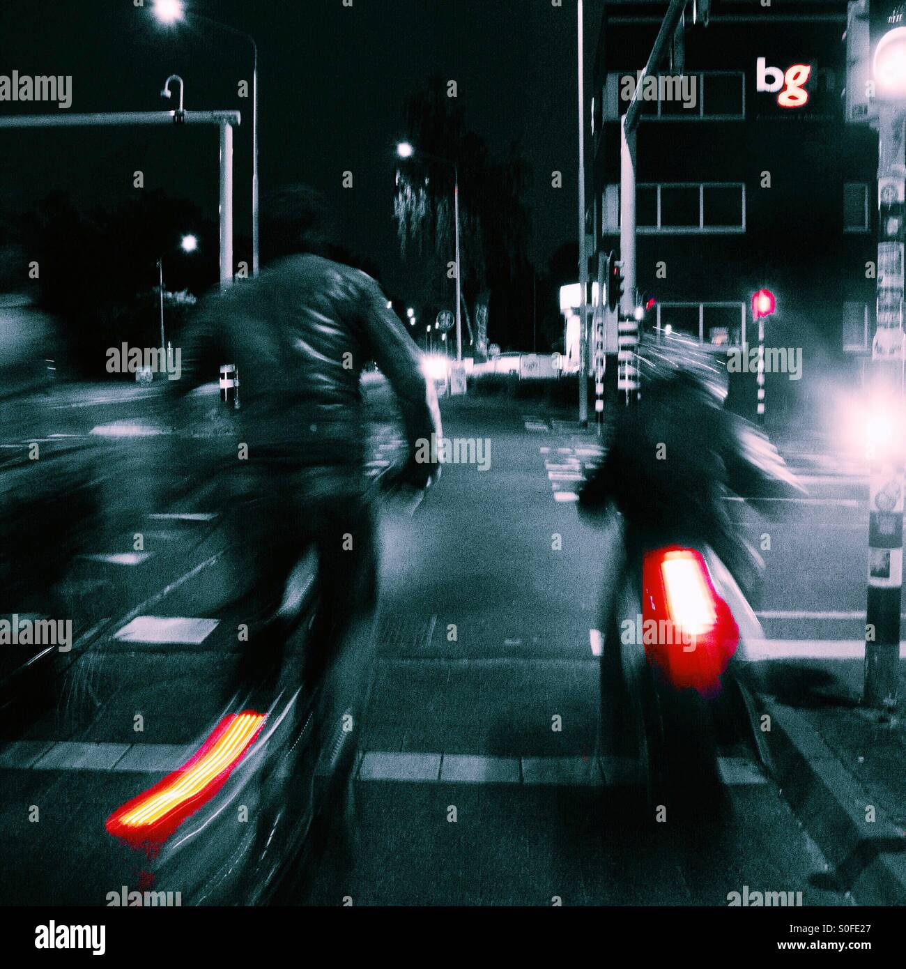 Hurrying home on the bicycles late at night. Stock Photo