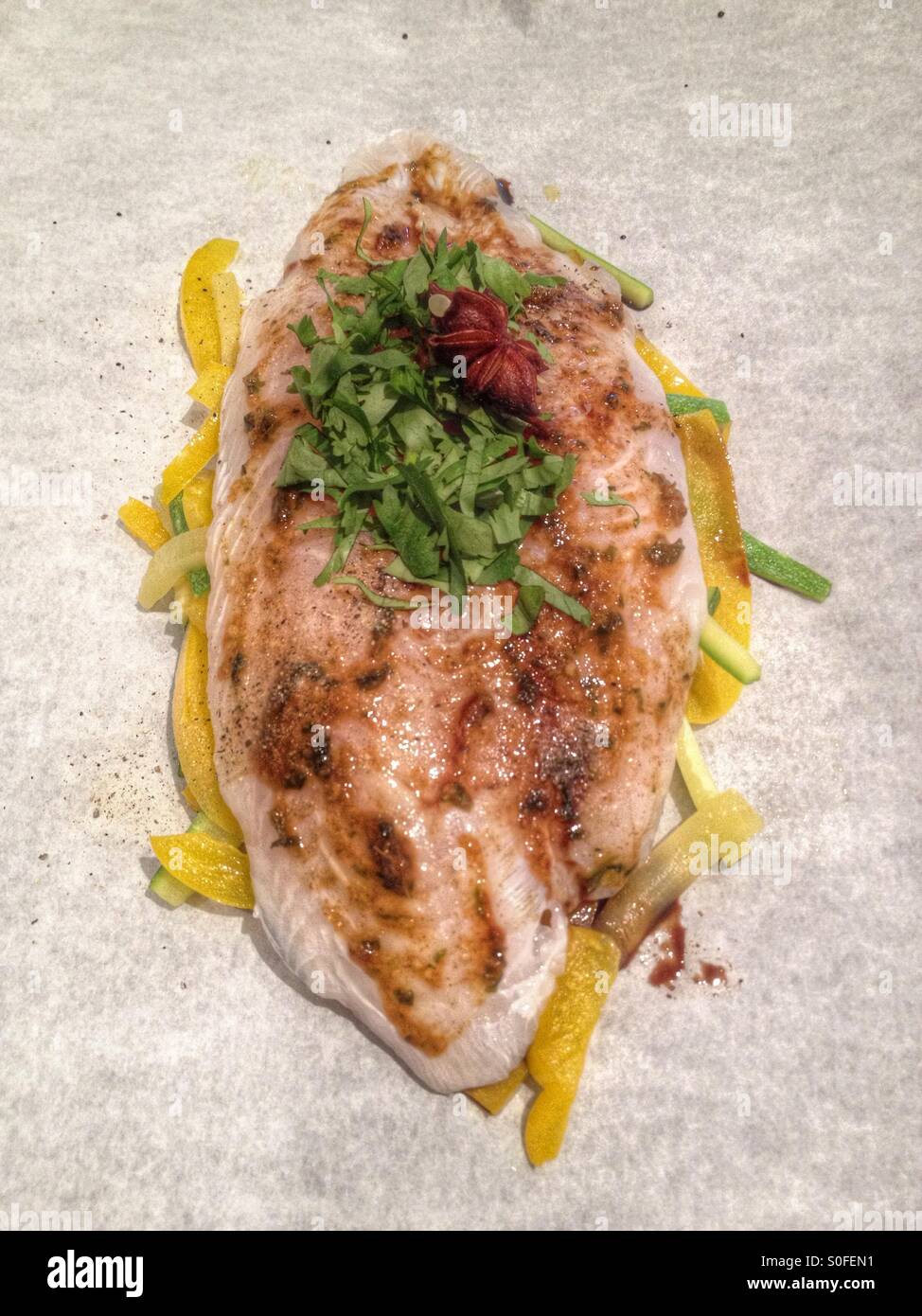 Fish ready for the oven on parchment paper Stock Photo Alamy
