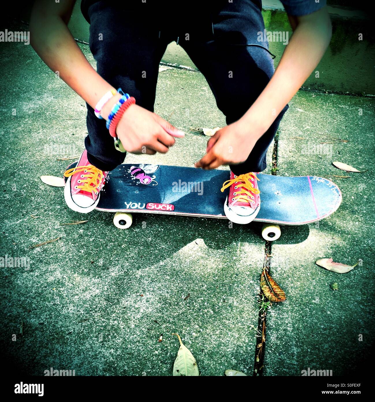 Skateboarder youth attitude on a sidewalk. - Smartphone Captured Stock Image