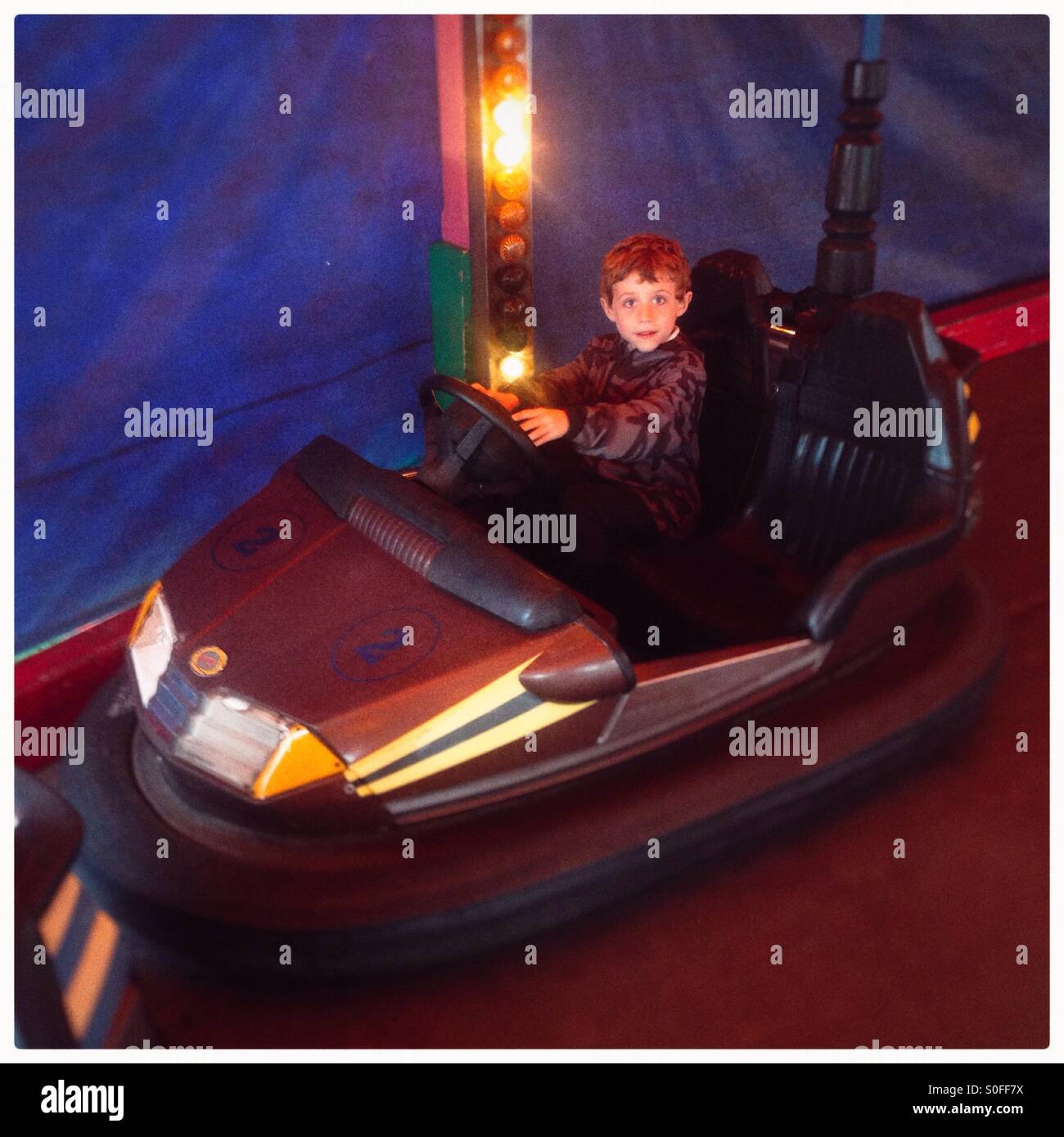 Six year old boy in a fairground bumper car! - Smartphone Captured Stock Image