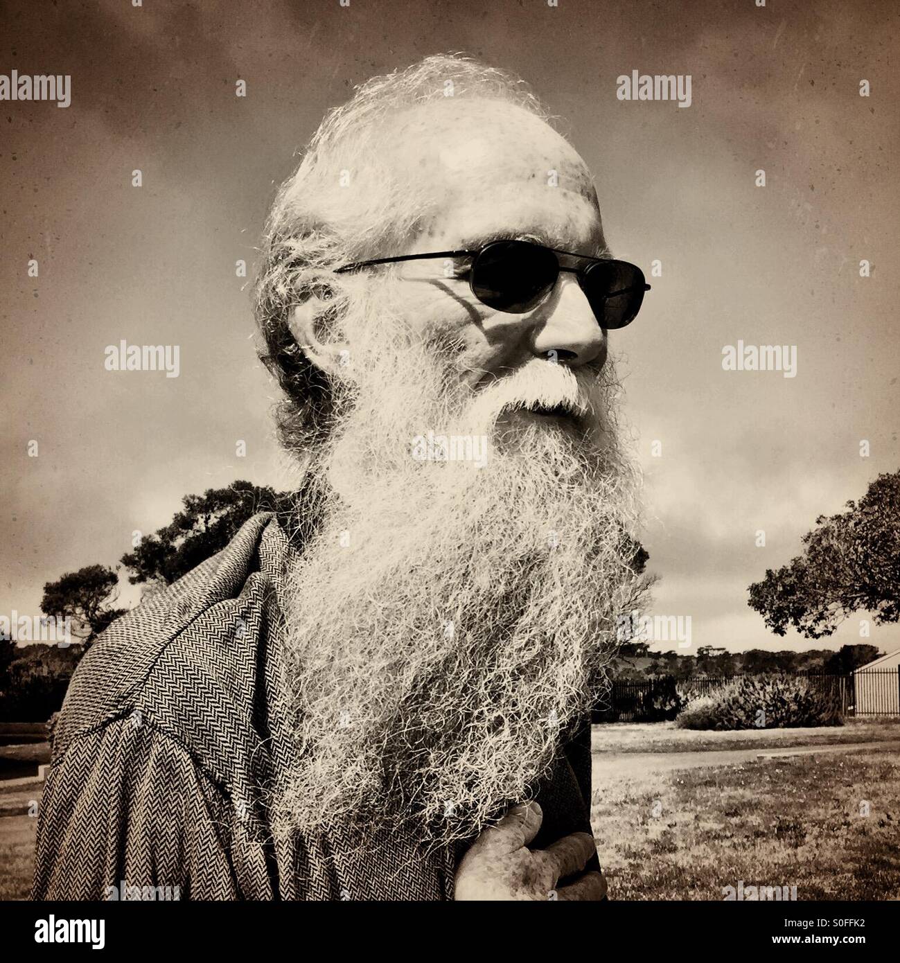 Elderly San Francisco man with long white gray beard and sunglasses. Sepia tone. California USA. - Smartphone Captured Stock Image