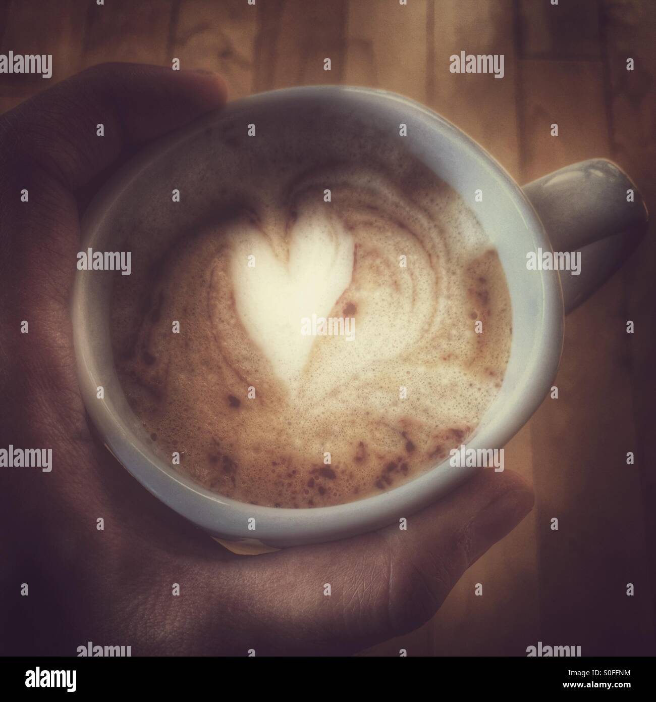 Hand holding a cup of coffee - Smartphone Captured Stock Image