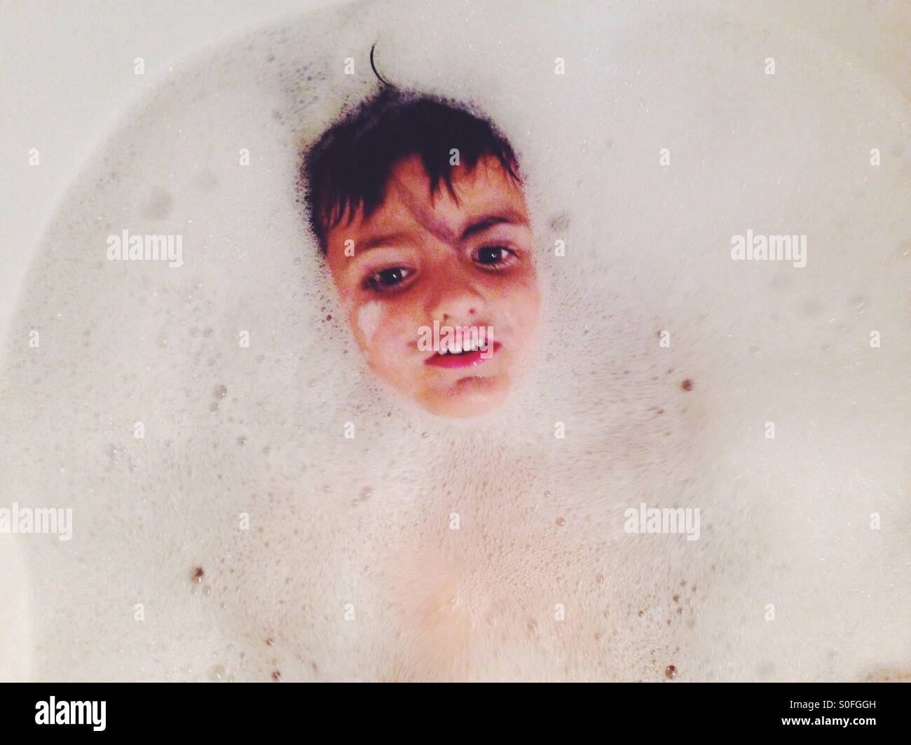 Three years old boy having a bath Stock Photo