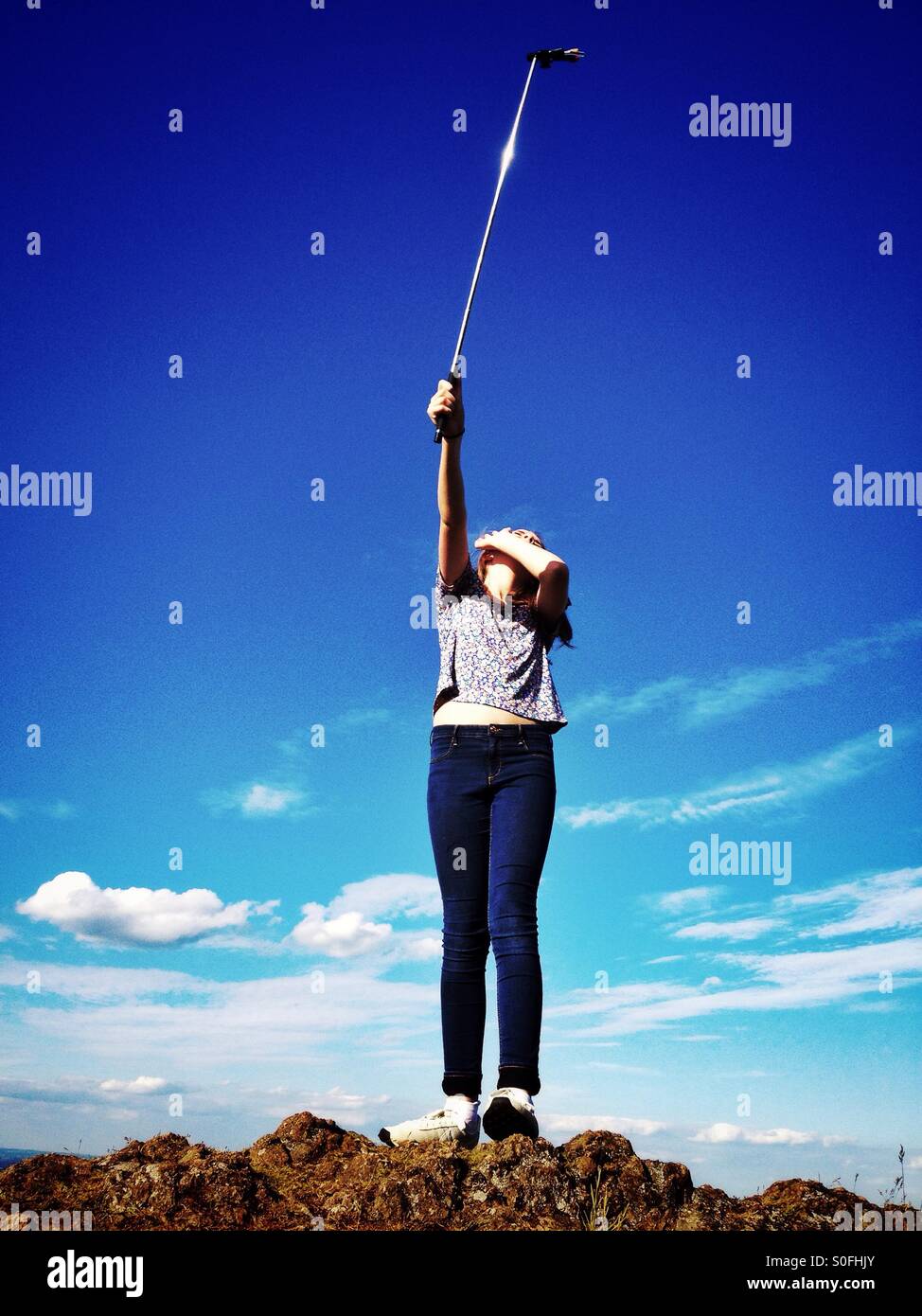 Girl taking photo with a selfie stick - Smartphone Captured Stock Image
